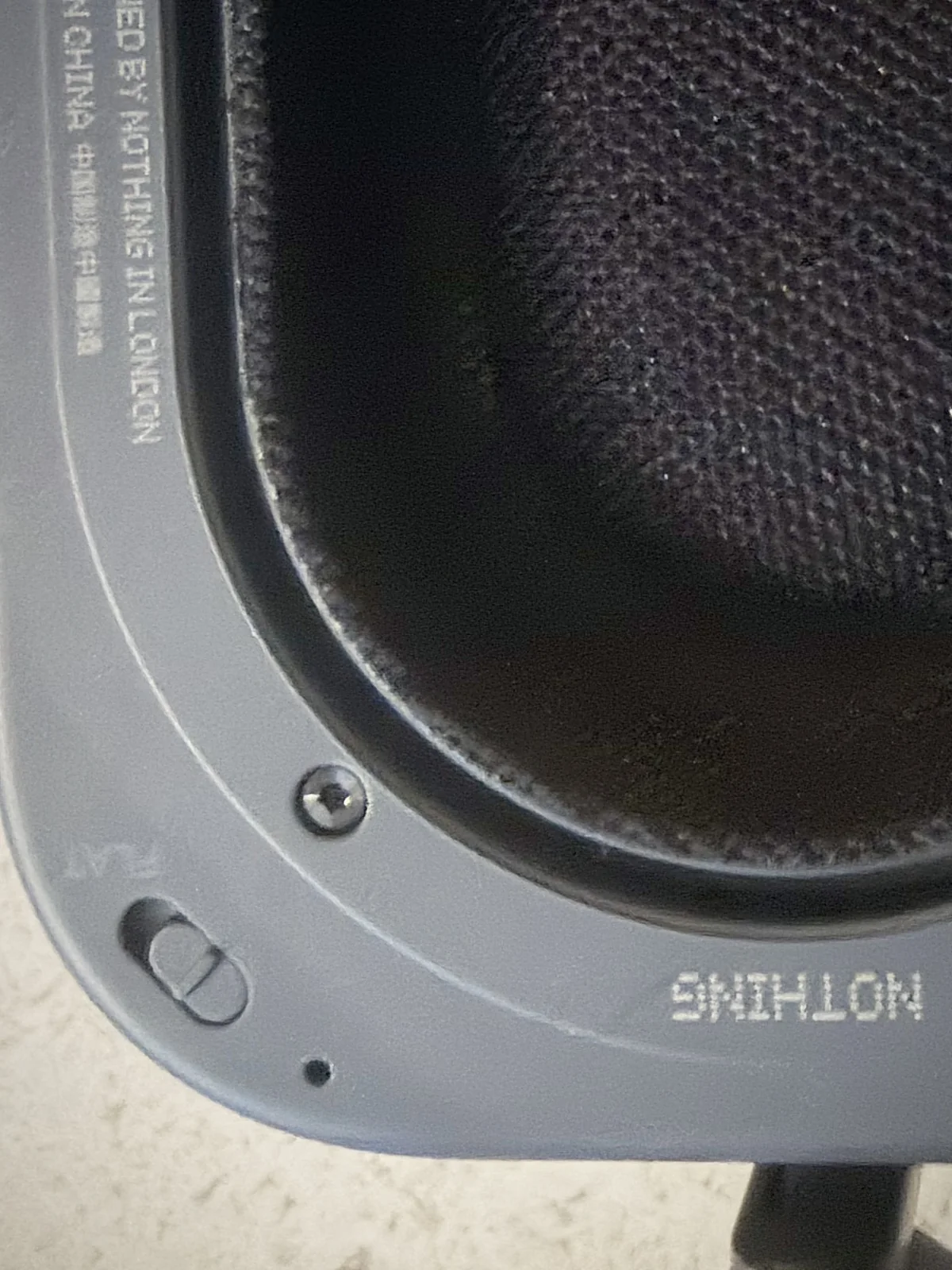 The Flat EQ switch on the Nothing Headphone (1) Pro ear cup, dark on dark